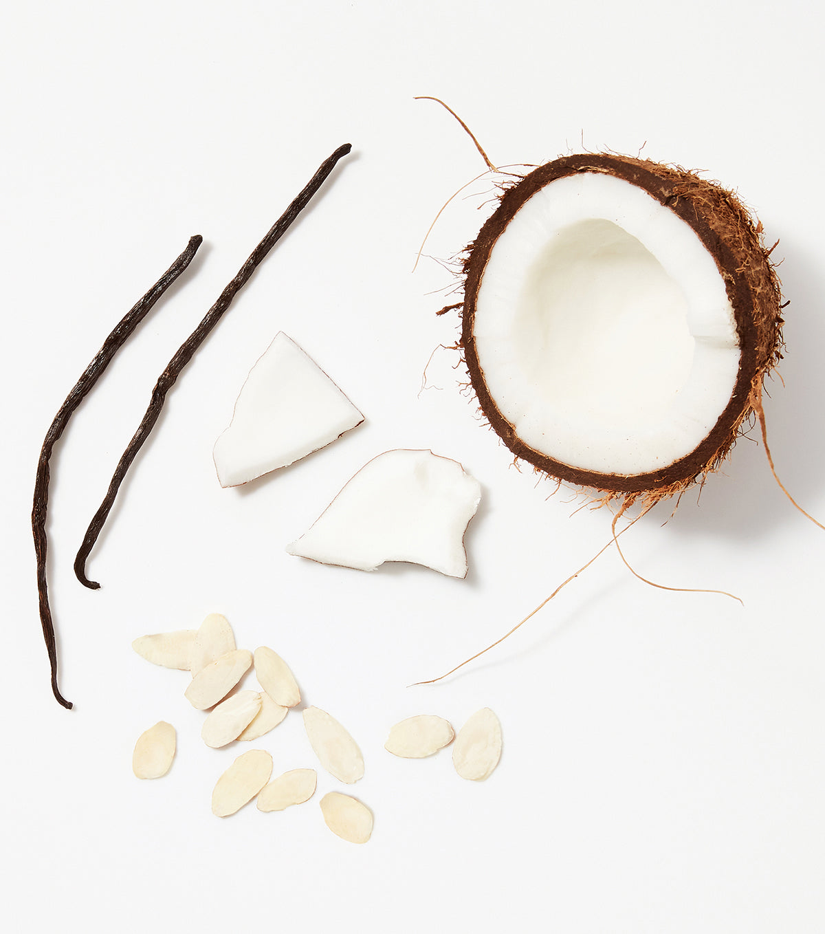 A close-up of natural coconut and almond ingredients used in NYM hair care products.